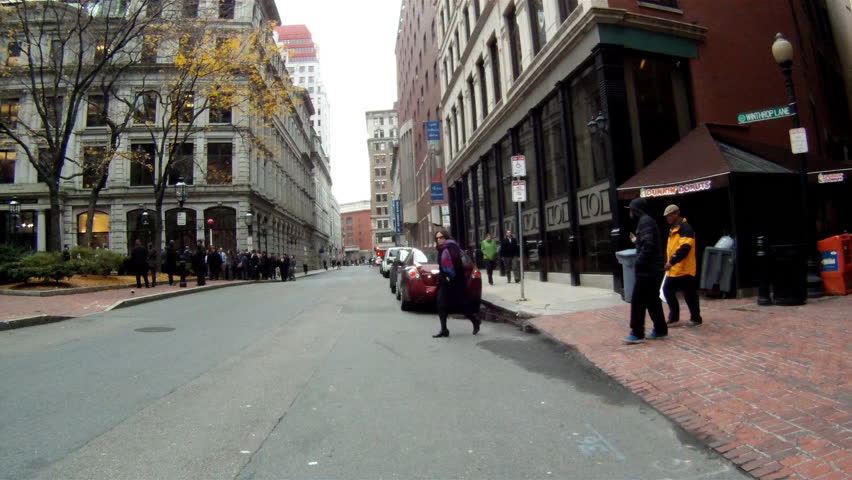 BOSTON, MASSACHUSETTS, USA - CIRCA 2011; Pedestrians cross street in downtown