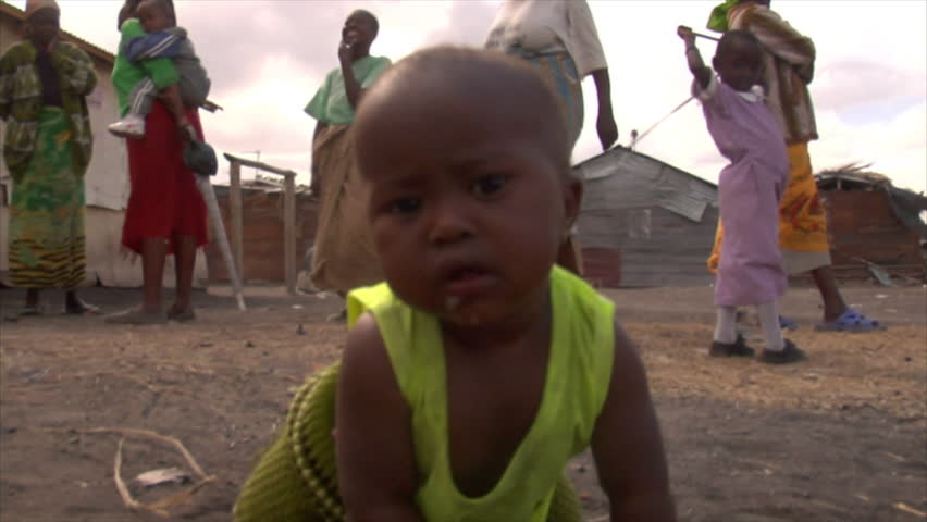 Kenya - Circa 2006: Unidentified little baby on all four's stares into camera,