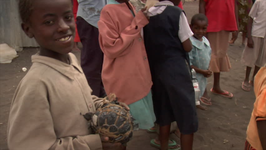 Kenya - Circa 2006: Unidentified little boy holds a handmade ball in arm