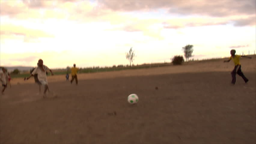 KENYA - CIRCA 2006: Unidentified kids run and play soccer circa 2006 in Kenya.