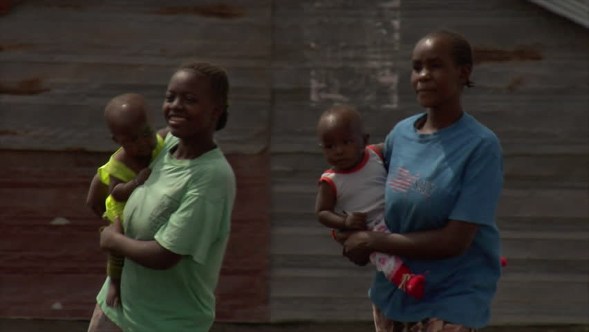KENYA - CIRCA 2006: Unidentified African women walk and hold children circa 2006