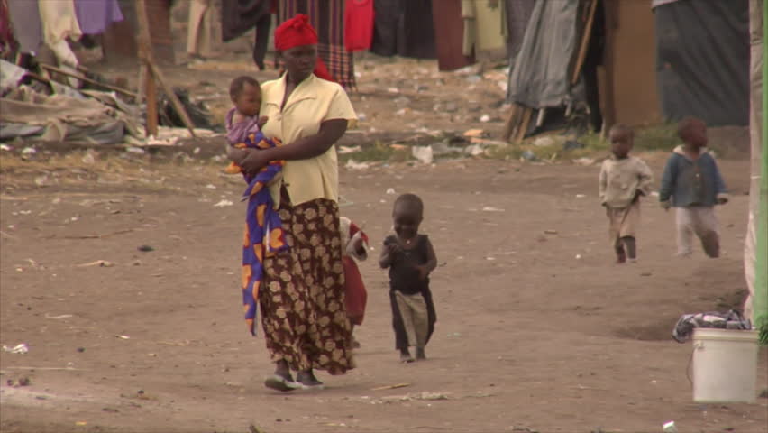 KENYA - CIRCA 2006: Unidentified African woman walks up a street followed by