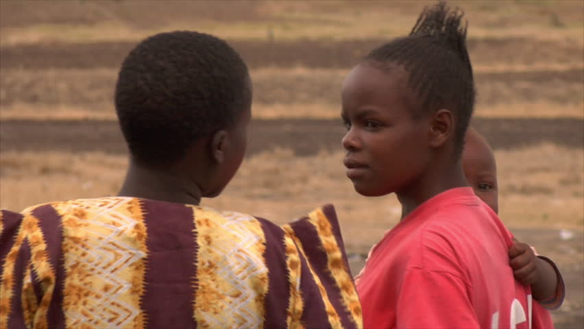 KENYA - CIRCA 2006: Unidentified African women holding children and walking