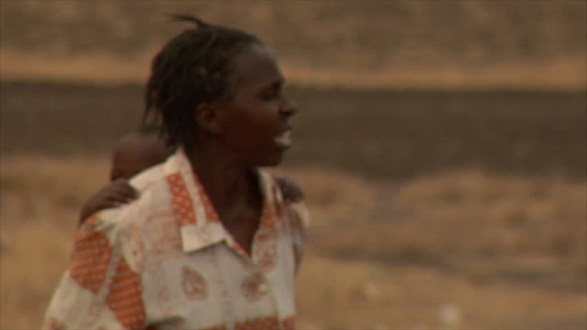 KENYA - CIRCA 2006: Unidentified woman with a baby on her back circa 2006 in