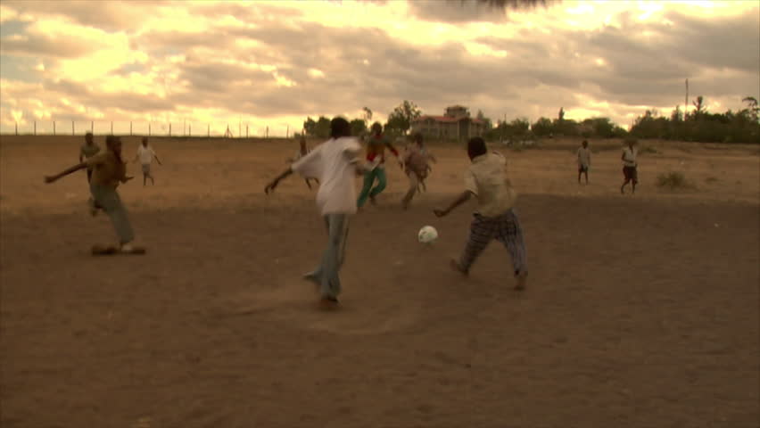 KENYA - CIRCA 2006: Group of unidentified boys run and play soccer circa 2006 in