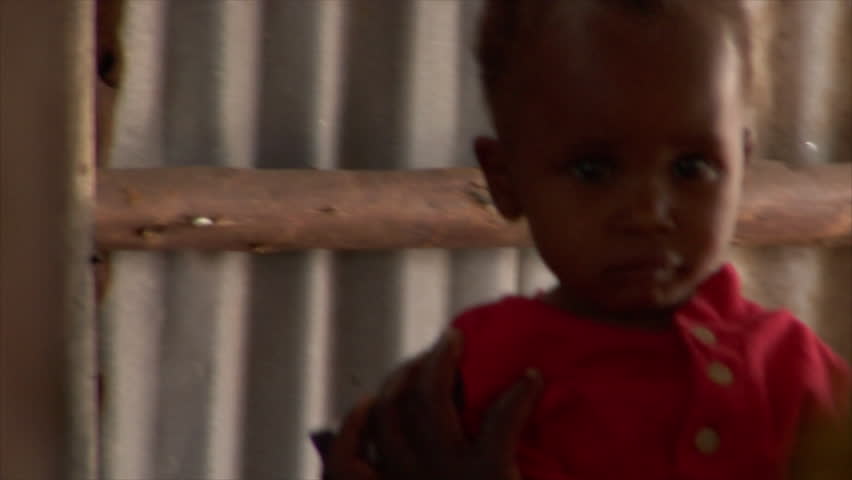 KENYA - CIRCA 2006: Unidentified little girl in a pink button-up shirt circa
