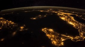 Planet Earth at night seen from the the International Space Station ISS. Italy lit night lights. Beautiful Planet Earth observed from space. Elements of this video furnished by NASA. 