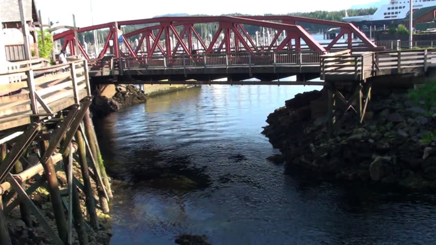 Red bridge spanning calm river