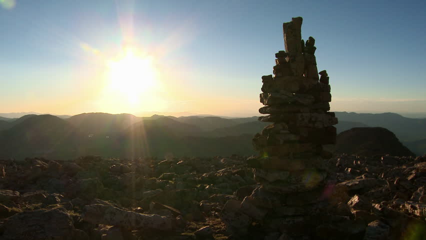 Large cairn with sunset