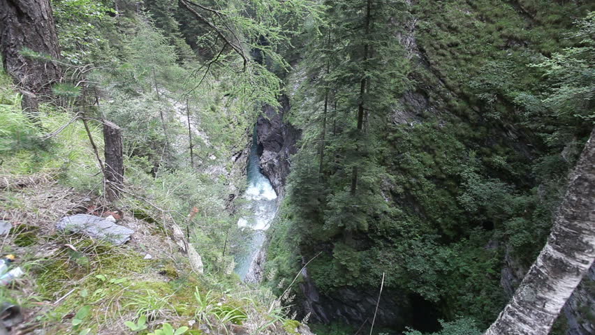 Deep chasm with waterfall in Switzerland