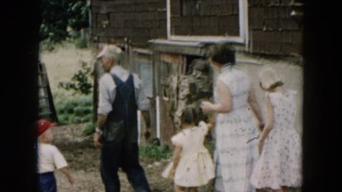 HICKSVILLE, NEW YORK 1957: a man leading a group down a path and into an old building
