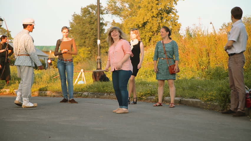 tourists playing Russian folk game gorodki