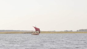 Vikings are floating on the river on the Drakkar