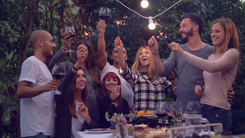 Friends holding lit sparklers at a dinner party
 Royalty-Free Stock Footage #20269069