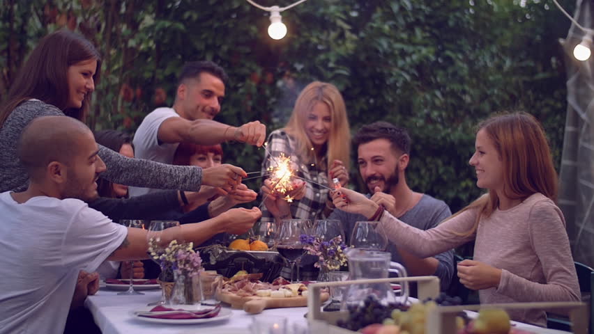 Friends holding lit sparklers at a dinner party
 Royalty-Free Stock Footage #20269096