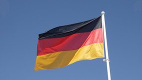 German flag in slow motion on flag-pole floating on wind 1080p HD footage - Germany national symbol waving in front of blue sky slow-mo 1920X1080 FullHD video