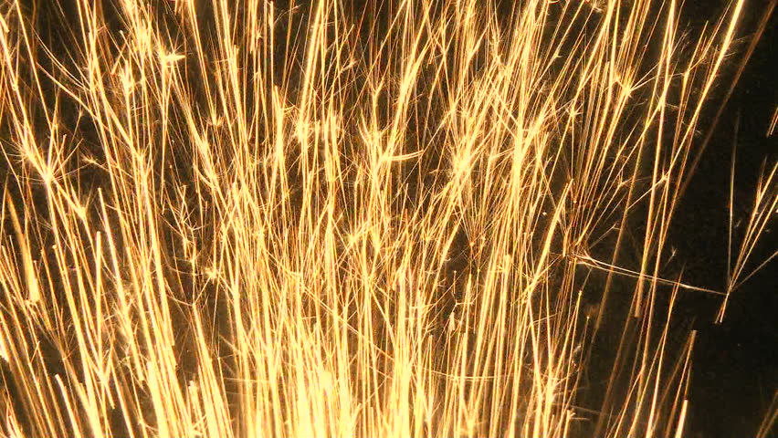 Stream of fire sparks shoot up through frame
