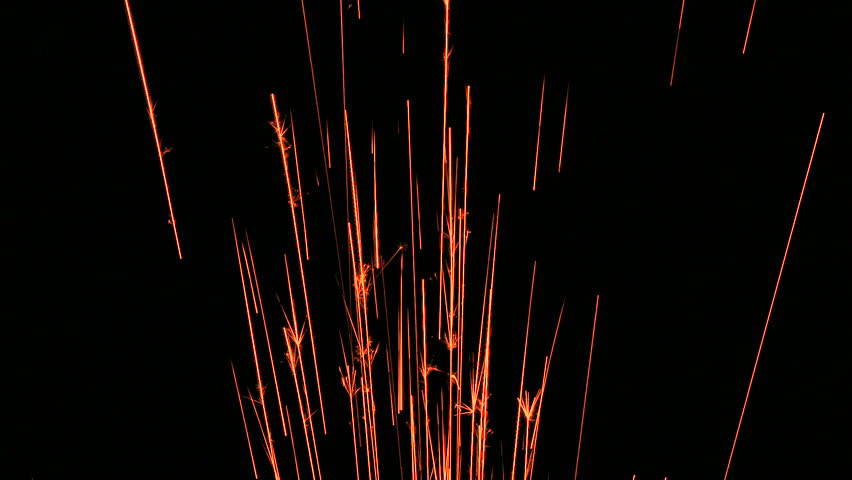 Red fire spark lines shoot through frame