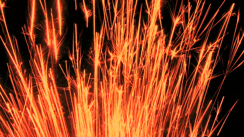Stream of red glowing sparks shoot up through frame