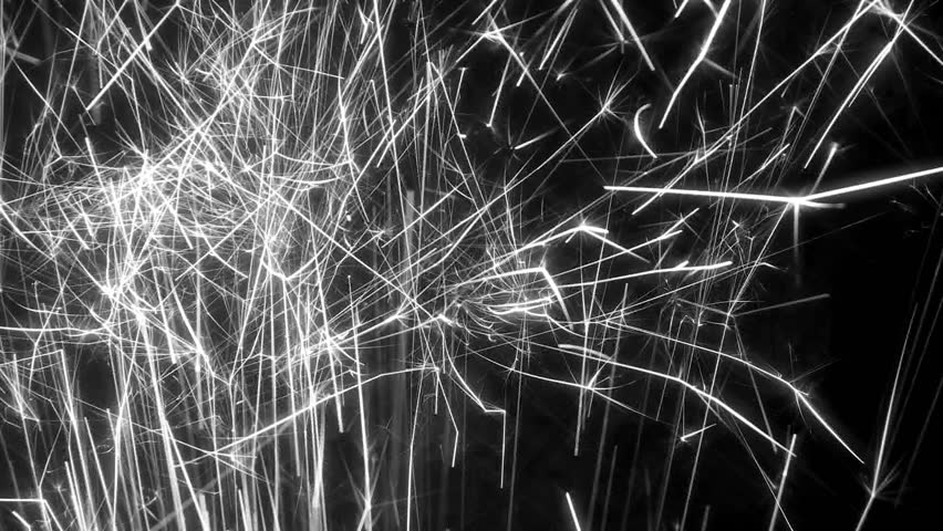 Stream of sparks shooting up through frame, black and white