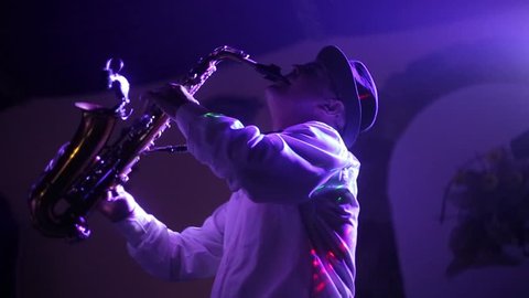 Musician playing alto saxophone on a gig, playing the saxophone, jazz, music