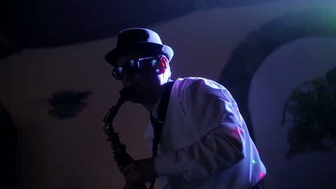 Jazz musician playing the saxophone , playing the saxophone , music backlit silhouette