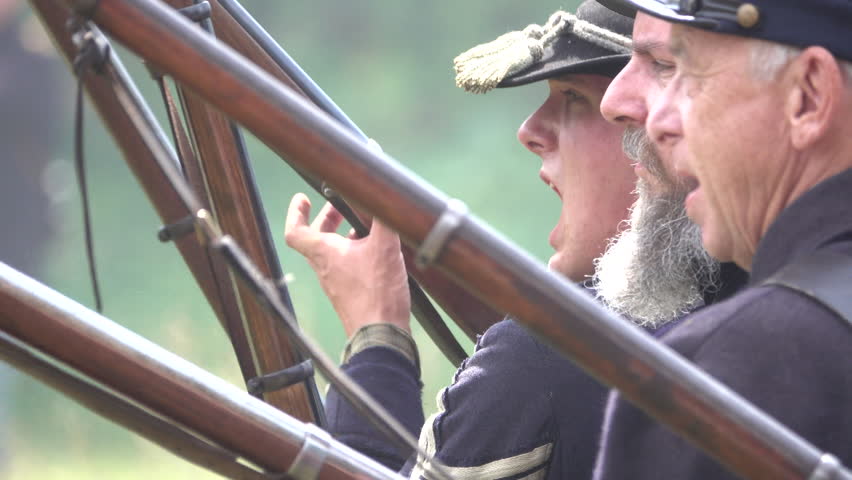 View of Union Civil War soldiers side view firing guns in battle