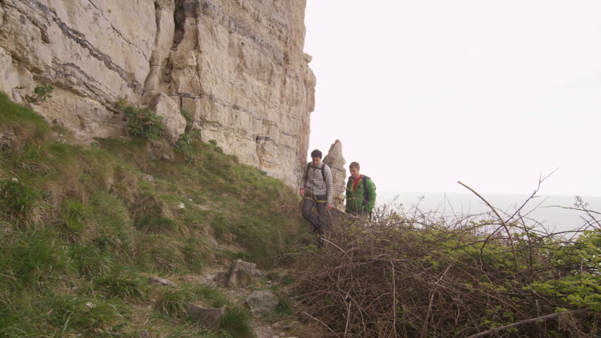 4K Male rock climbers hiking to location to begin a climb. Shot on RED Epic.