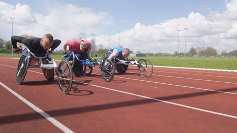 4K Disabled wheelchair athletics team competing in a race at race track. Shot on RED Epic. Video de stock