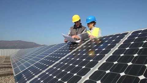 Engineers working on solar panels plant