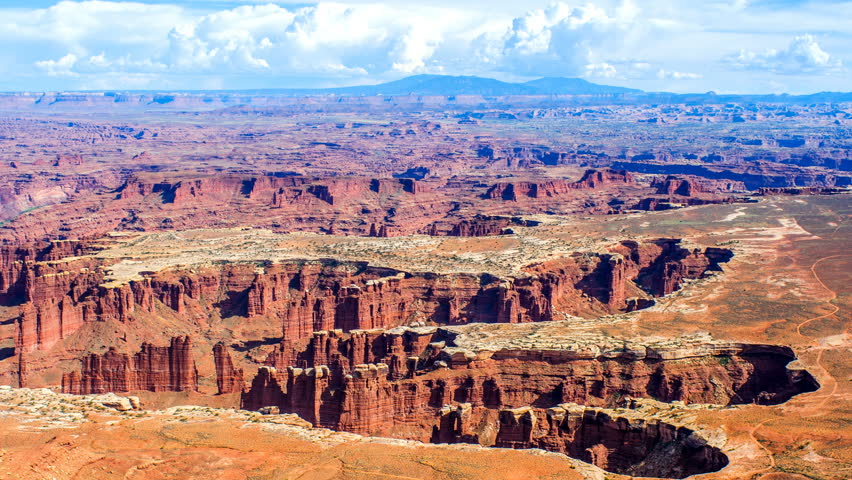 Canyonlands - A panoramic overview of clouds passing over steep red sandstone canyons carved by Colorado River in Canyonlands National Park,  Utah, USA.