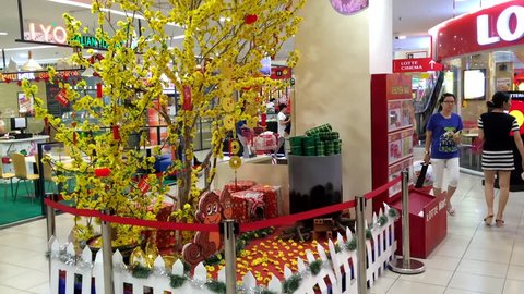 VUNG TAU, VIETNAM - FEBRUARY 18, 2016: Unidentified customers walk in a Lotte Mart supermarket decorated for Tet, Lunar New Year. 