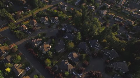 Sunset Aerial of Suburban Houses with Great of City in the Distance