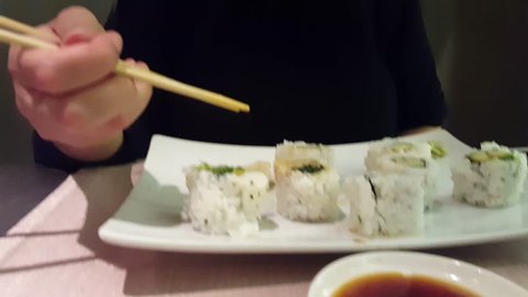 Close up of vegetarian sushi holding by chopstick