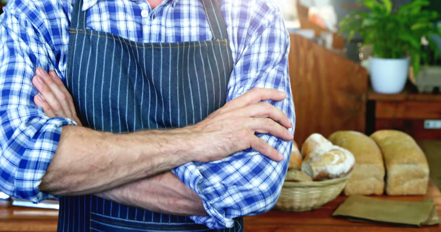 Portrait of smiling male staff standing in supermarket with his hands crossed 4k