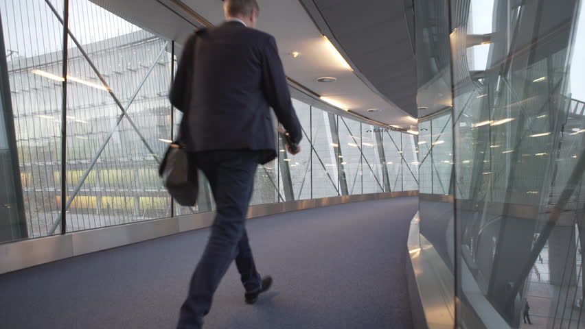 Brussels, February 2, 2015: Some people walking and talking at glass hallways at the European Parliament. | Shutterstock HD Video #20302087