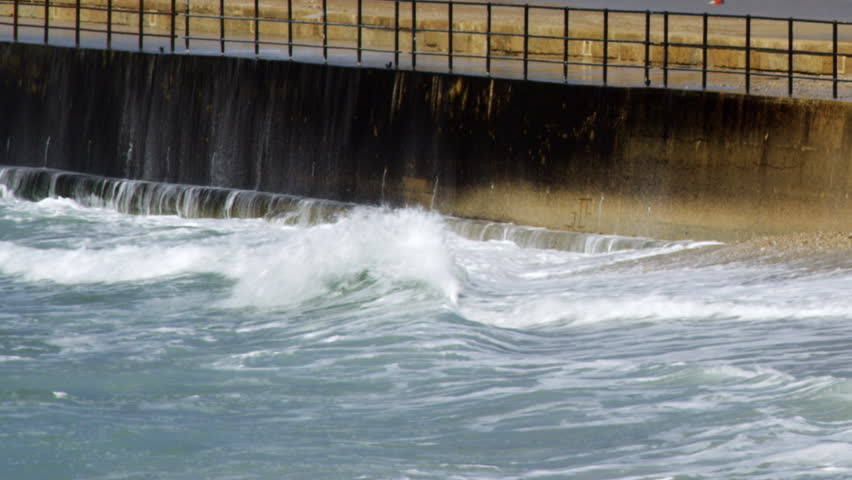 Waves hitting a retaining wall shot in Israel.