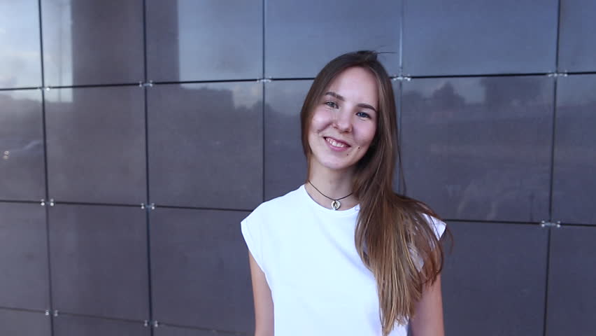 Woman Girl Lady Portrait Looking Camera Walking. Young Beautiful Student Business Female With Long Hair on the Background Building.