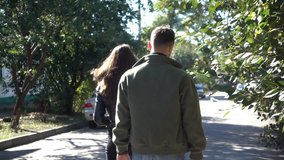 Young Couple Taking A Romantic Walk - Back View