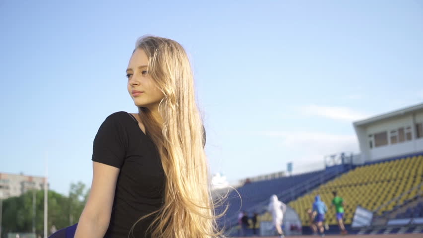 Young female athlete in the stadium.