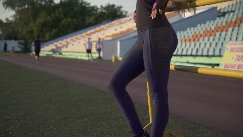 Young female athlete in the stadium.