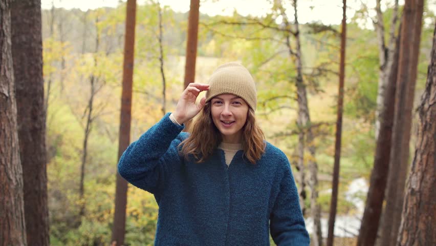 Girl have fun with her hat. Studet at vocation. Autumn in the forest