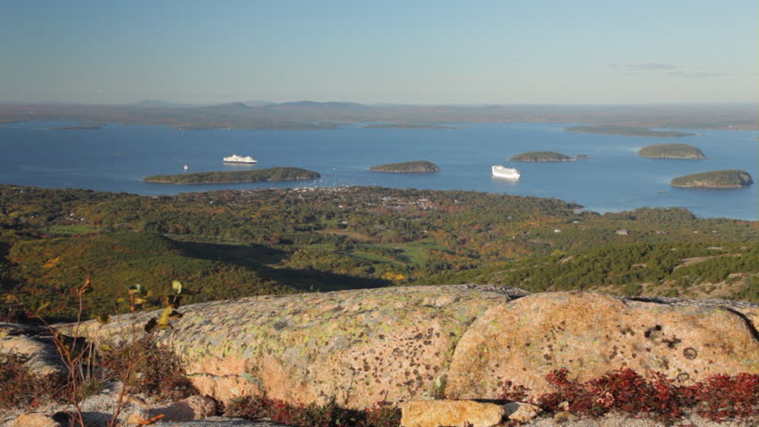 Late afternoon view from the top of Cadillac Mountain (granite in foreground) of Bar Harbor, Frenchman Bay, and the Porcupine Islands; Acadia National Park, Maine.