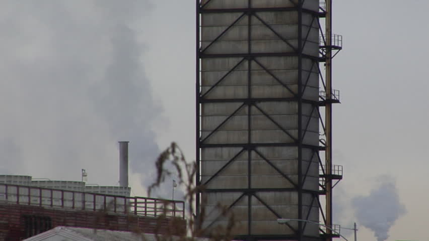 A smoke stack behind another building.