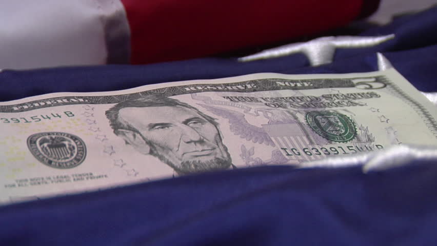 Close up on Five Dollar Bill on American Flag
