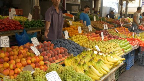 ATHENS, GREECE- SEPTEMBER, 16, 2016:  3 axis gimbal shot walking past produce stalls in the central market of athens, greece