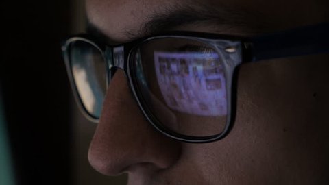 man watching porno content on internet reflection on glasses