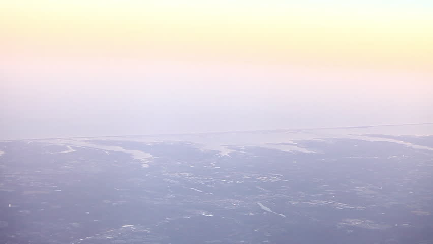Aerial view of horizon with pink and yellow sky.
