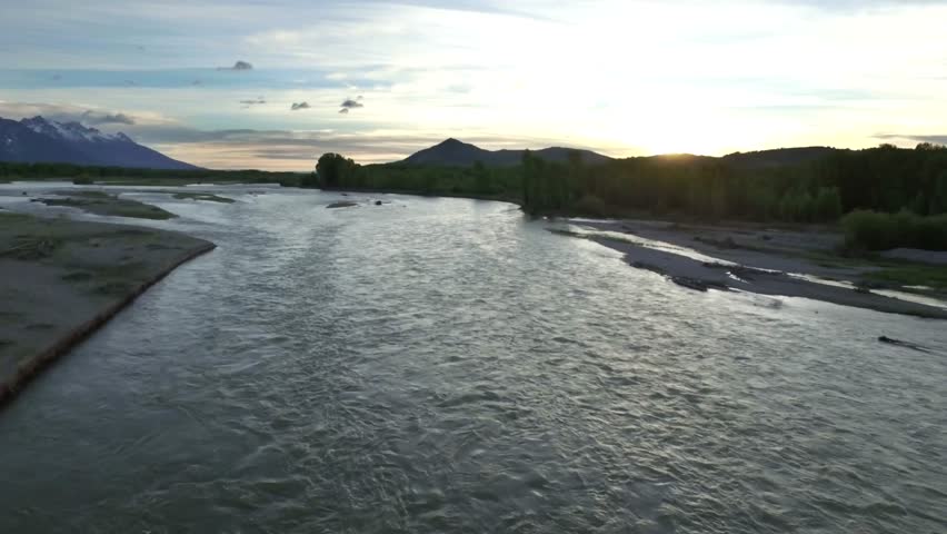 Drone view of sunset sky with snowcapped mountains and river 6