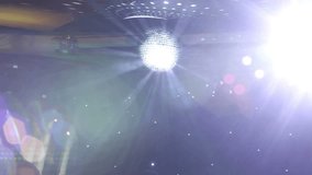 Two disco ball hanging in the hall, mirrored disco ball in a disco, the light rays are reflected from the ball, video, HD